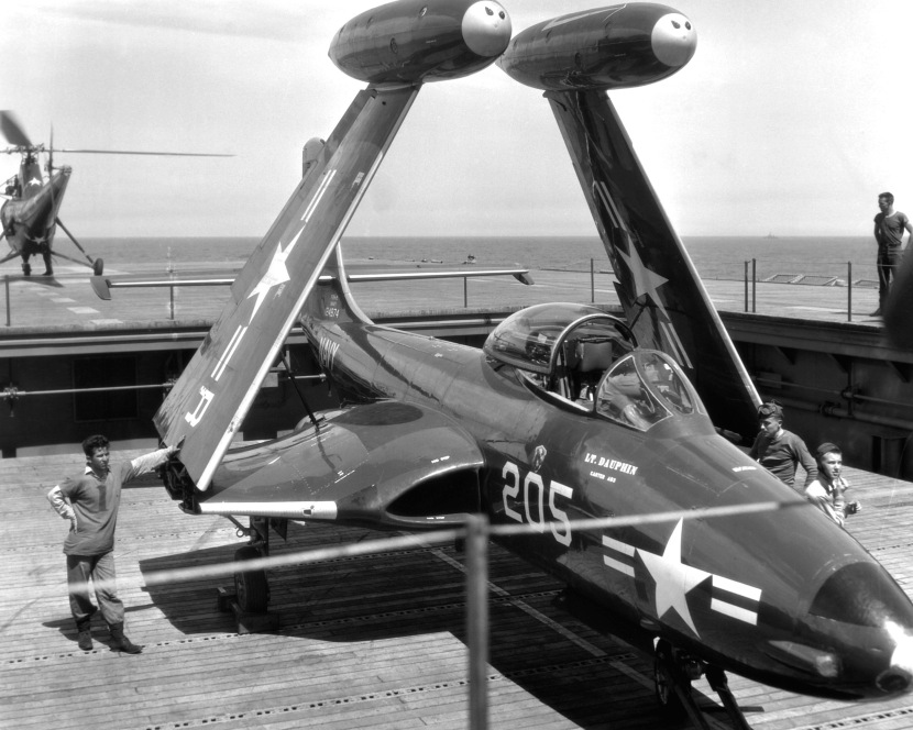 A F2H-2 "Banshee" is serviced aboard the USS ESSEX (CV-9), for a strike on Communist targets in Korea, by crewmen of the 27,000 ton aircraft carrier.  A "Banshee" is hauled to the flightdeck of the carrier on the forward elevator. NARA FILE #:  80-G-432627