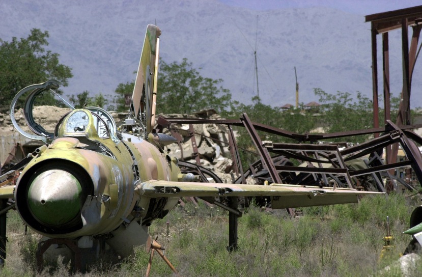The wreckage of an abandoned Soviet Mig-21 Fishbed aircraft sits with rusted hardware in an open field near Bagram Air Base, Afghanistan, during Operation ENDURING FREEDOM. After over 20 years of war and civil unrest, the Afghan landscape is painted with pieces of old military hardware and unexploded ordnance.